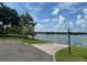 Scenic lake view featuring a paved access point with lush greenery and a clear blue sky at 1252 Lake Willisara Cir # Ge, Orlando, FL 32806
