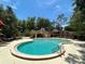 Beautiful community pool surrounded by lush greenery and a shaded cabana area at 1252 Lake Willisara Cir # Ge, Orlando, FL 32806