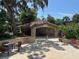 Community pool house featuring a tiled roof, seating area, and landscaping for social gatherings at 1252 Lake Willisara Cir # Ge, Orlando, FL 32806