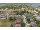 Aerial view showcasing the house in a residential area with mature trees at 126 San Carlo Rd, Davenport, FL 33896