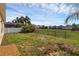 Large backyard features a fenced perimeter, well maintained lawn, and mature trees at 126 San Carlo Rd, Davenport, FL 33896
