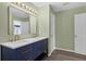 Bathroom featuring a dual sink vanity, a large mirror and contemporary fixtures at 126 San Carlo Rd, Davenport, FL 33896