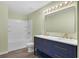Stylish bathroom with a dual sink vanity, ample storage and shower-tub combination at 126 San Carlo Rd, Davenport, FL 33896