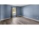 Bedroom with a large window offering plenty of natural light and gray wood-look floors at 126 San Carlo Rd, Davenport, FL 33896