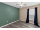 Inviting bedroom with neutral tones, ceiling fan, and a window with navy curtains at 126 San Carlo Rd, Davenport, FL 33896