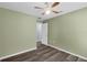 Cozy bedroom featuring a ceiling fan, neutral walls and wood-look floors at 126 San Carlo Rd, Davenport, FL 33896