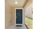 Welcoming front entry featuring a stylish dark blue door with elegant hardware and a neutral-toned exterior at 126 San Carlo Rd, Davenport, FL 33896