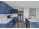 Modern kitchen with blue cabinets, quartz countertops, and stainless steel appliances at 126 San Carlo Rd, Davenport, FL 33896