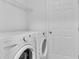 Bright laundry room featuring a washer and dryer and a wire rack shelf at 126 San Carlo Rd, Davenport, FL 33896