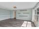 Bright living area featuring wood-look floors, custom shelving, and abundant natural light from a large window at 126 San Carlo Rd, Davenport, FL 33896