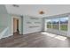Inviting living space featuring light-filled windows, decorative shelves, and stylish wood-look laminate flooring at 126 San Carlo Rd, Davenport, FL 33896