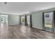 Spacious living room filled with natural light, showcasing sleek laminate flooring and a neutral color scheme at 126 San Carlo Rd, Davenport, FL 33896
