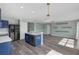 Open-concept living room with modern kitchen, hardwood-style floors and neutral colors at 126 San Carlo Rd, Davenport, FL 33896
