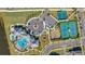 Overhead view of community amenities, including a pool, playground, tennis courts, basketball court, and ample parking spaces at 13323 Panama Beach Ct, Orlando, FL 32827