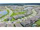 Aerial view of community with homes, playground, and lake at 13323 Panama Beach Ct, Orlando, FL 32827
