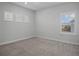 Bright bedroom with neutral carpet, white walls, and shuttered windows at 13323 Panama Beach Ct, Orlando, FL 32827