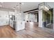 Bright kitchen with stainless appliances and island opens to living and dining spaces at 13323 Panama Beach Ct, Orlando, FL 32827