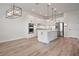 White kitchen featuring an island, stainless steel appliances, pendant lighting and ample cabinet space at 13323 Panama Beach Ct, Orlando, FL 32827