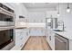 Well-appointed kitchen features white cabinets, stainless steel appliances, and contemporary fixtures at 13323 Panama Beach Ct, Orlando, FL 32827