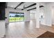 Spacious living room featuring dark wood ceiling beams and light wood flooring at 13323 Panama Beach Ct, Orlando, FL 32827