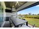 Outdoor patio features a built-in kitchen with grill, ceiling fan, and views of the backyard and pool at 13323 Panama Beach Ct, Orlando, FL 32827