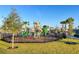 A vibrant, fenced playground with slides and climbing structures, offering a safe and fun environment for children in the community at 13323 Panama Beach Ct, Orlando, FL 32827