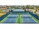 Aerial view showcasing two well-maintained tennis courts, perfect for friendly matches and active living within the community at 13323 Panama Beach Ct, Orlando, FL 32827