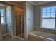 Bright bathroom featuring a walk-in shower and bathtub, offering a clean and relaxing space at 1414 Stickley Ave, Kissimmee, FL 34747