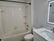 Bathroom featuring bright vanity, a framed mirror, and a shower-tub combo at 1414 Stickley Ave, Kissimmee, FL 34747