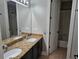 Bathroom featuring double sink vanity with granite countertop and a framed mirror at 1414 Stickley Ave, Kissimmee, FL 34747