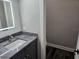 Elegant bathroom featuring a gray vanity with a marble countertop and a decorative mirror at 1414 Stickley Ave, Kissimmee, FL 34747