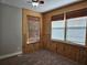 Unique bedroom featuring bamboo accent walls, plush carpet, and natural window coverings at 1414 Stickley Ave, Kissimmee, FL 34747