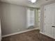 Bedroom features neutral walls, plush carpet, a bright window, and a standard closet at 1414 Stickley Ave, Kissimmee, FL 34747