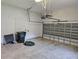 View of the garage interior showing block wall, door, storage lift and trash can at 1414 Stickley Ave, Kissimmee, FL 34747