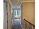 Hallway featuring neutral walls and carpet leading to a bright room with built-in bench seating at 1414 Stickley Ave, Kissimmee, FL 34747