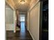 Hallway with wood floors, neutral paint, and views of other rooms, creating a warm and inviting ambiance at 1414 Stickley Ave, Kissimmee, FL 34747