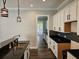 Spacious kitchen with sleek black countertops, white cabinets, and modern hanging lights at 1414 Stickley Ave, Kissimmee, FL 34747