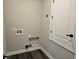 Functional laundry room with utility hookups and a doorway, offering convenience and practicality at 1414 Stickley Ave, Kissimmee, FL 34747
