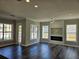 Bright living room with a modern electric fireplace and large windows providing great natural light at 1414 Stickley Ave, Kissimmee, FL 34747