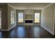 Bright living room with a modern electric fireplace and large windows with great natural light at 1414 Stickley Ave, Kissimmee, FL 34747