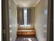 Hallway nook with plush carpet, bright window, curtains, and custom built-in bench and storage at 1414 Stickley Ave, Kissimmee, FL 34747