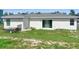 The backyard of this home features green grass and a sliding glass door at 1418 Kissimmee Ct, Kissimmee, FL 34759