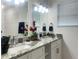 Bathroom with double sinks, granite countertop and modern fixtures at 1418 Kissimmee Ct, Kissimmee, FL 34759