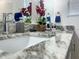 Close up view of bathroom vanity with double sink, granite countertop and modern faucet at 1418 Kissimmee Ct, Kissimmee, FL 34759