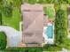 An aerial view of the property, highlighting the roof, backyard pool, landscaping and paver driveway at 1420 Palmer Ave, Winter Park, FL 32789