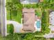 An aerial view of a home, showcasing the backyard pool, lush landscaping, and paver driveway at 1420 Palmer Ave, Winter Park, FL 32789