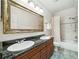 Bathroom with double sinks, granite counters, large mirror, and bath/shower combination at 1420 Palmer Ave, Winter Park, FL 32789
