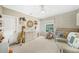 Bedroom with crib, plush giraffe, changing table, neutral color palette, and carpeted floor at 1420 Palmer Ave, Winter Park, FL 32789