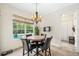 Bright breakfast nook overlooking the pool, complete with a chandelier and a table for four at 1420 Palmer Ave, Winter Park, FL 32789