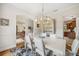 Elegant dining room with a modern chandelier, white furniture, and colorful artwork, perfect for entertaining at 1420 Palmer Ave, Winter Park, FL 32789